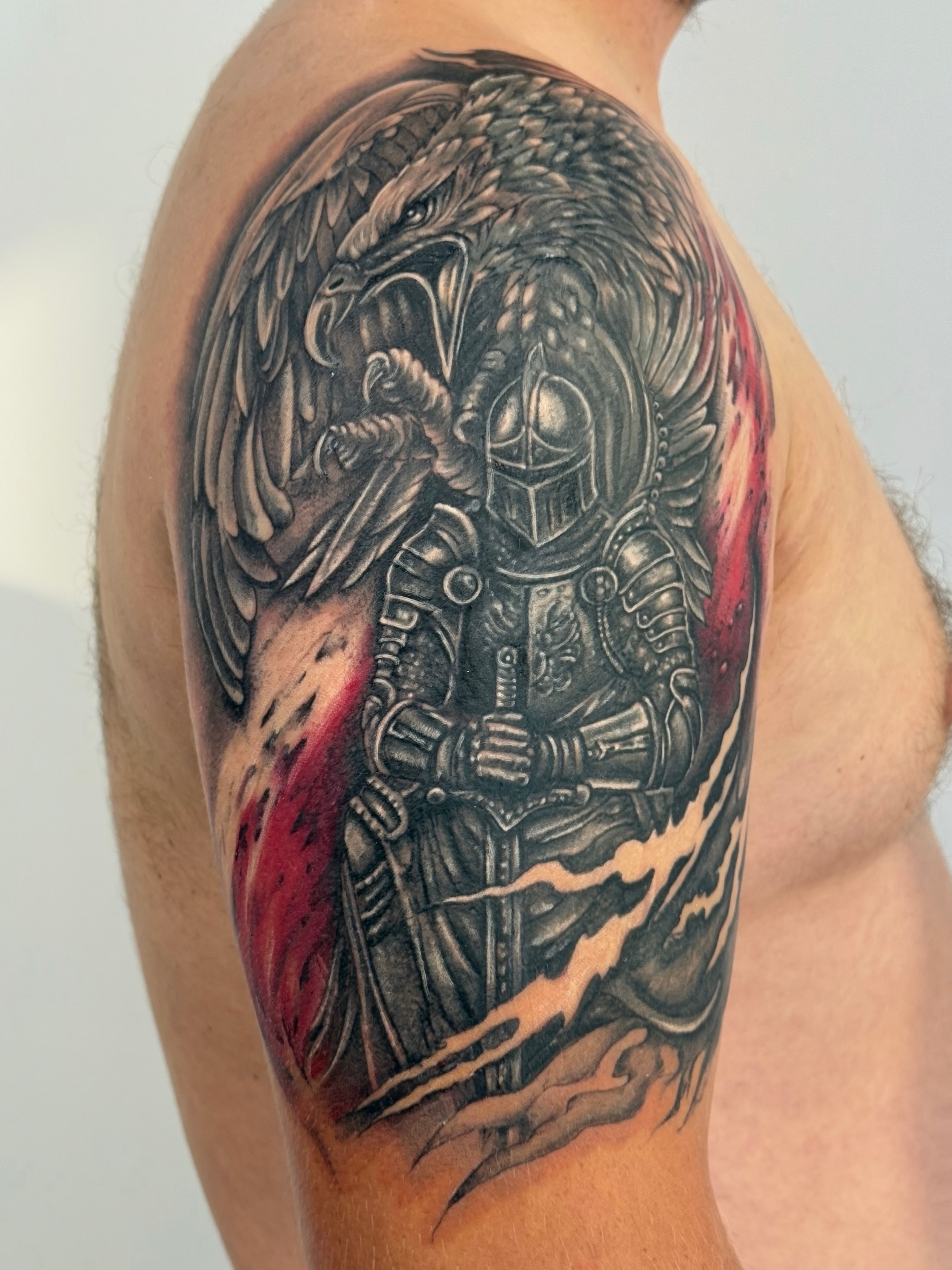 Fresh knight and eagle upper-arm Cover-Up tattoo with red and white Polish flag accents