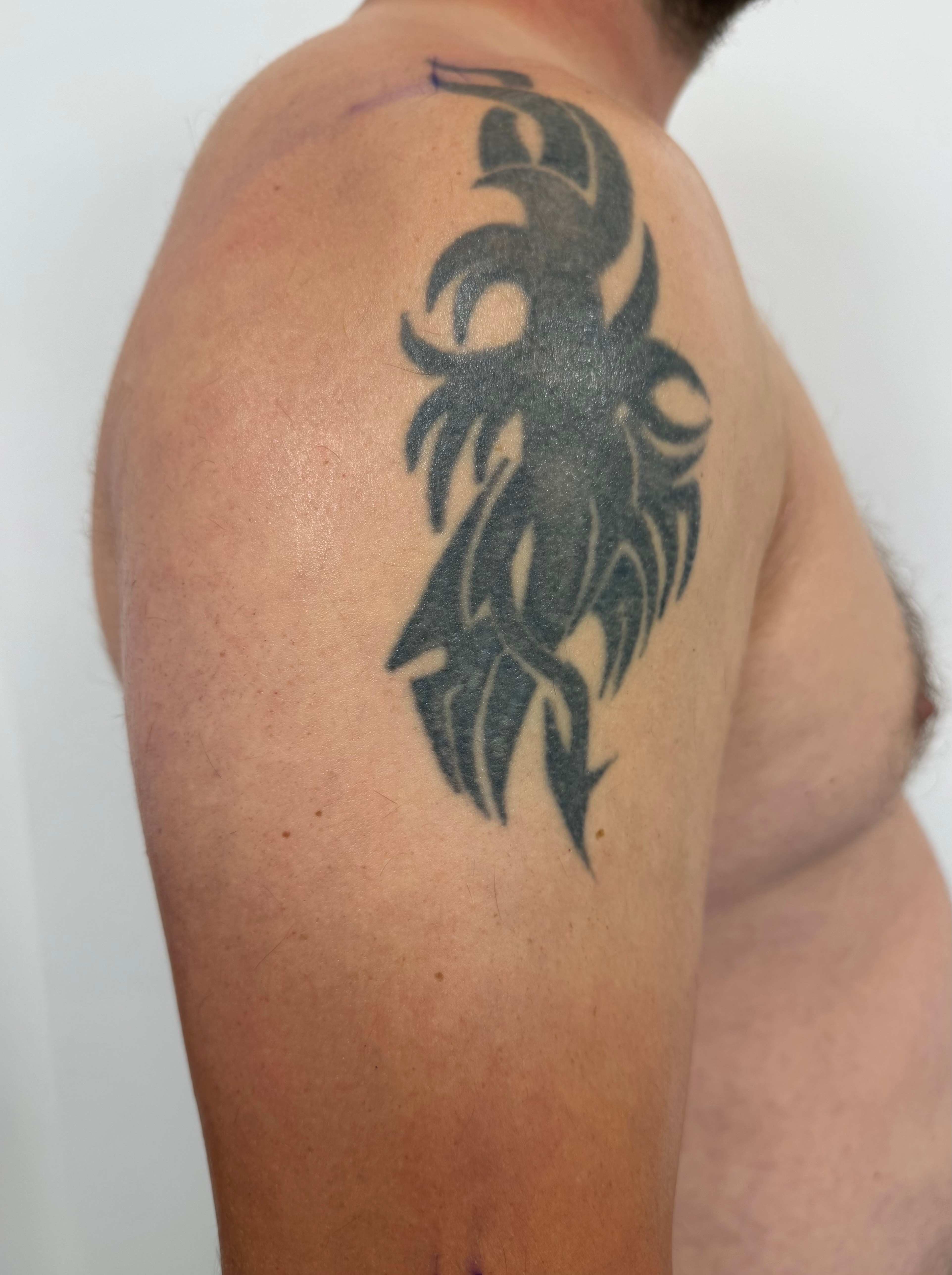 Old black tribal-style upper-arm tattoo before the knight, eagle and Polish flag Cover-Up