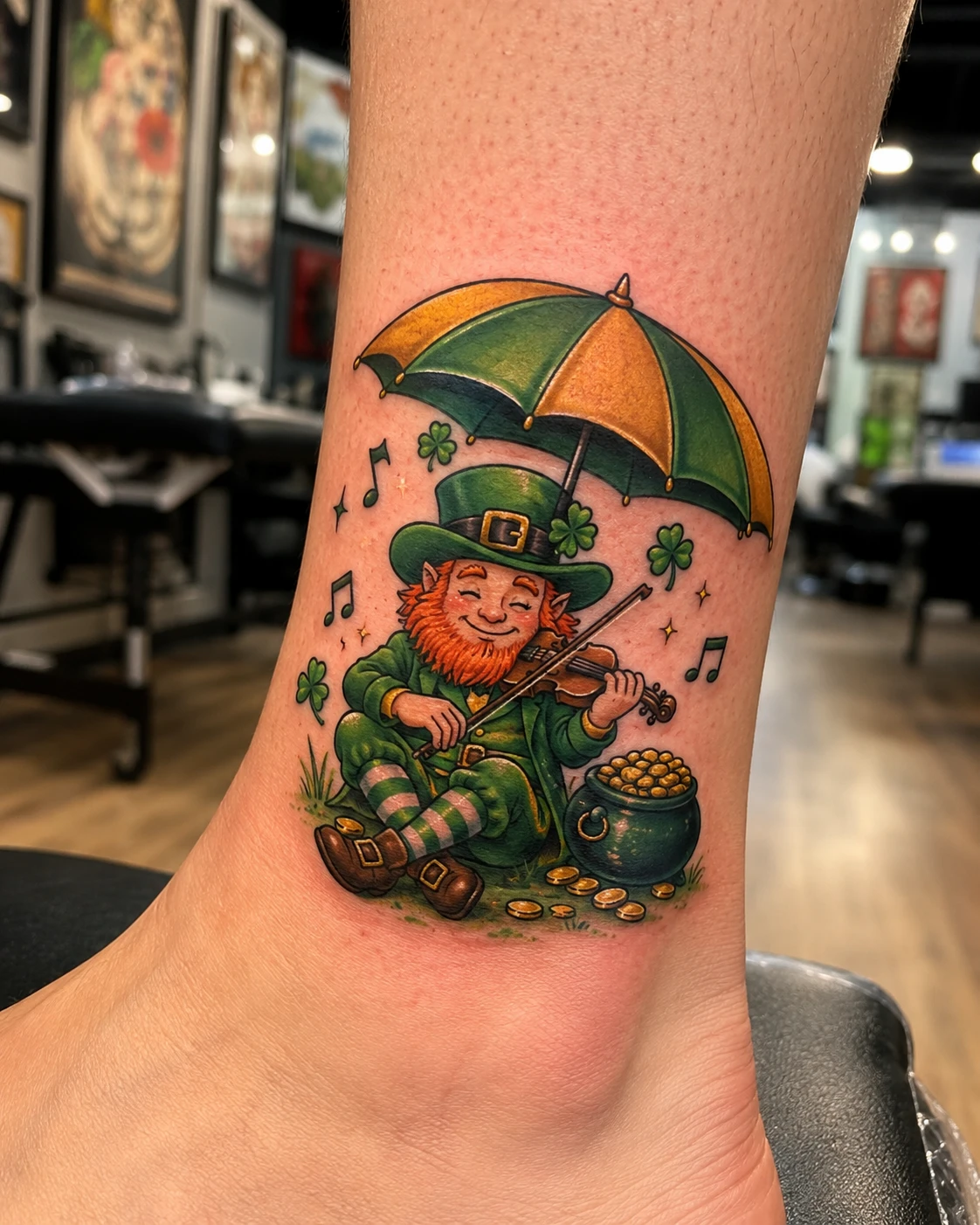Leprechaun violin tattoo with umbrella and shamrocks on ankle