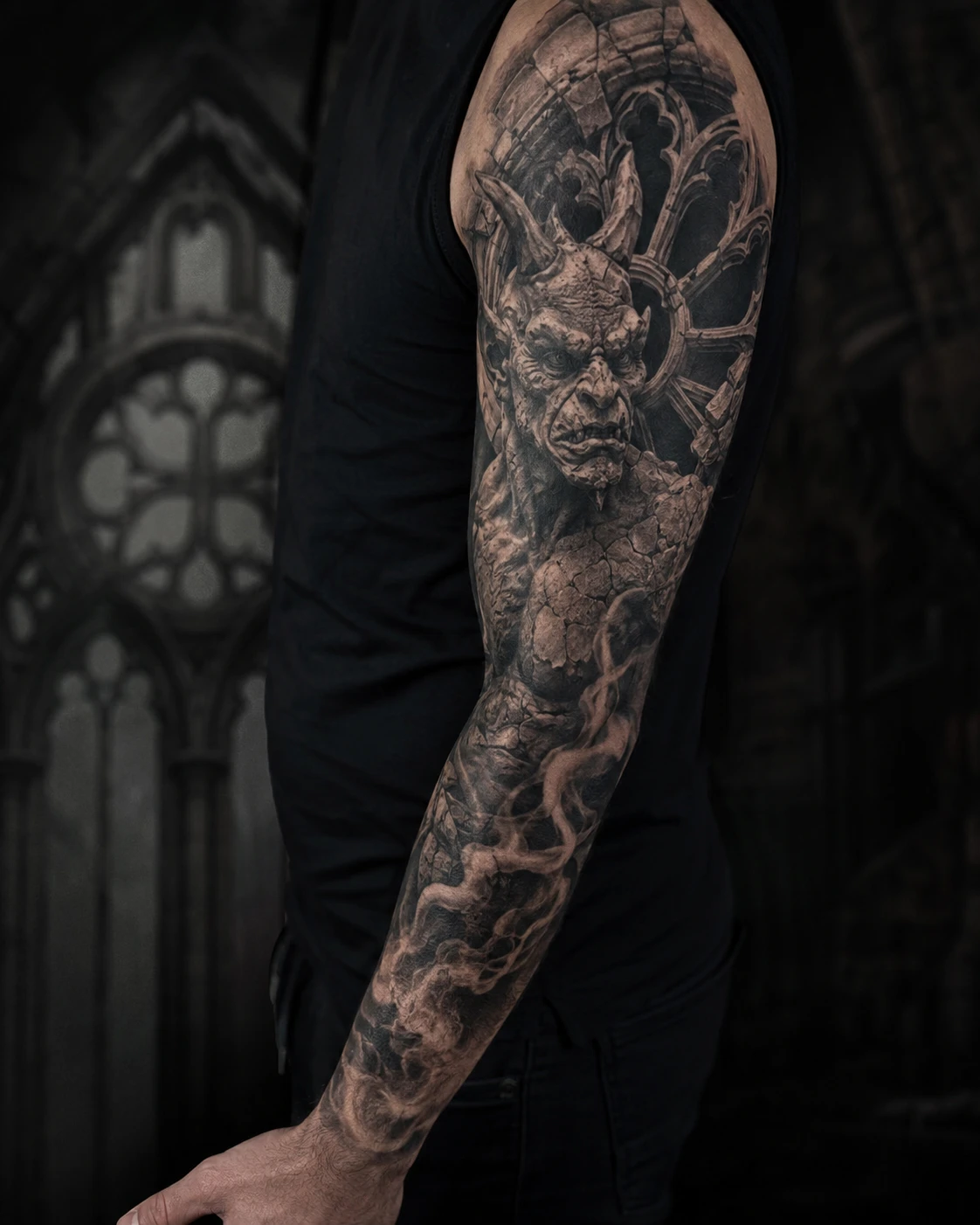 Stone gargoyle and cathedral arches tattoo across full arm sleeve