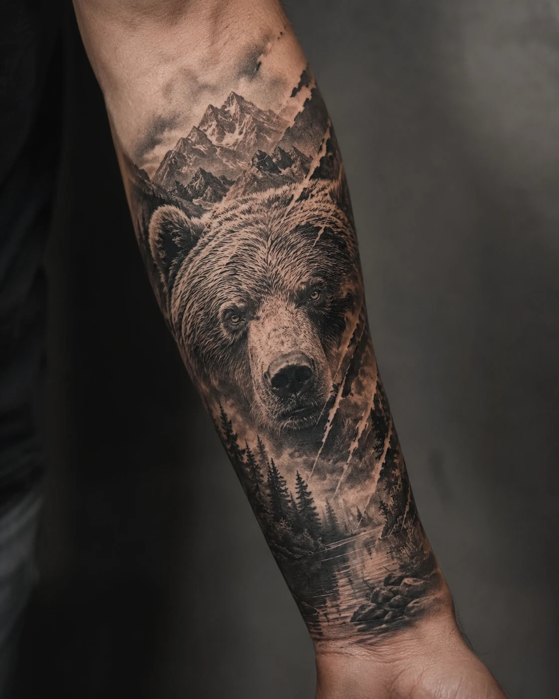 Large bear beneath sharp mountain ridges and dark fir trees