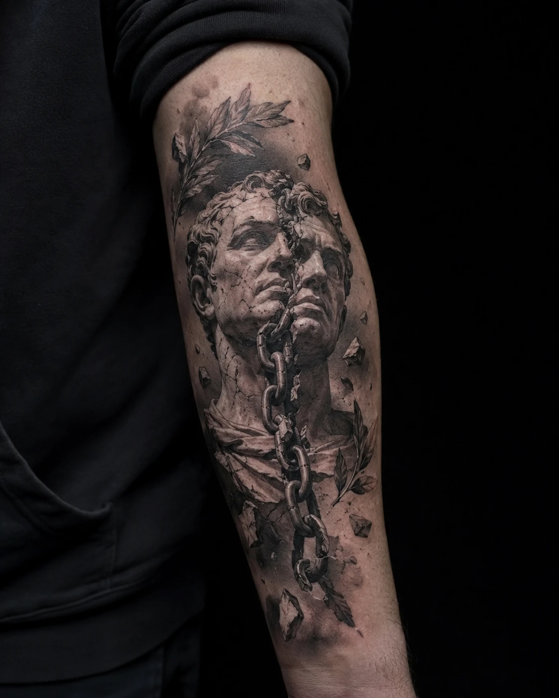 Marble figure strains beneath wrapped chains with cracked stone, deep folds and dramatic gallery shadow.