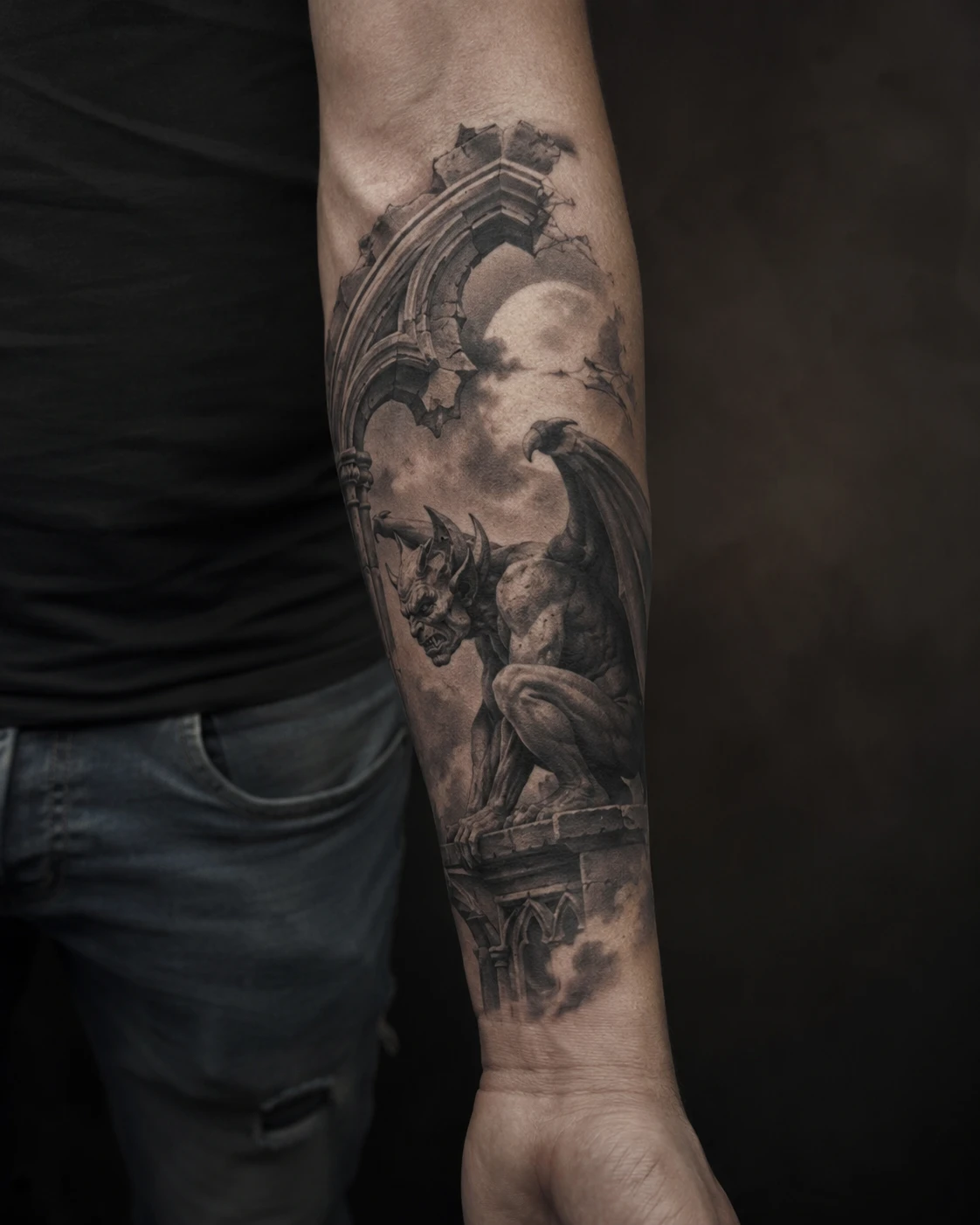 Crouching stone gargoyle beneath a Gothic arch and pale moon on the forearm.