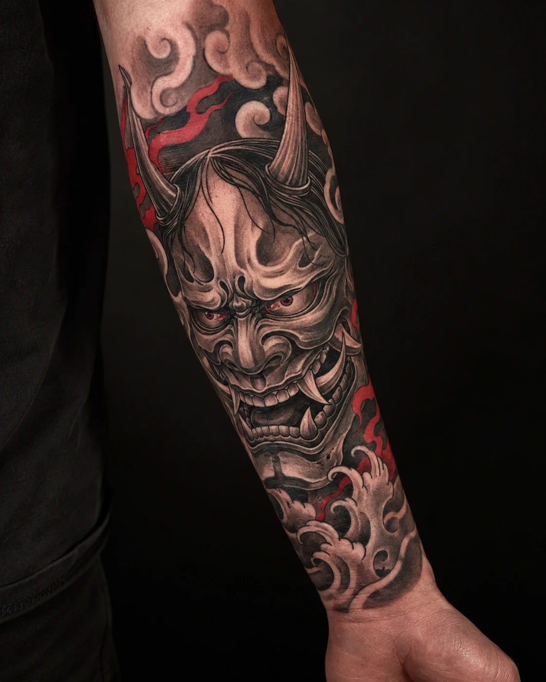 Fierce Hannya mask fills the composition with sweeping horns, dark shading and sharp red accents.