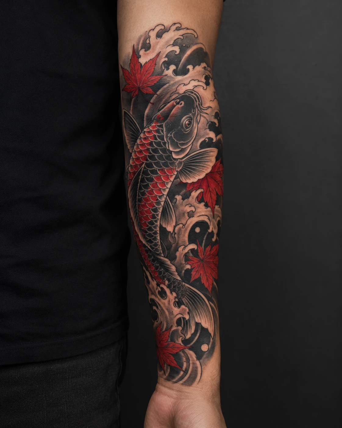 Forearm tattoo of a koi in Japanese waves with red maple leaves and accents.