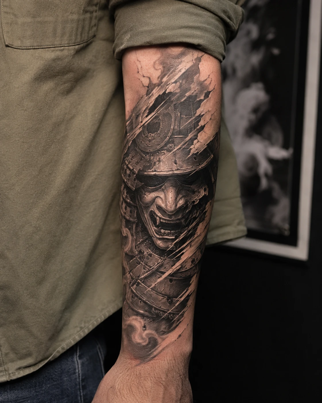 Oni face and samurai armour tattoo on the forearm