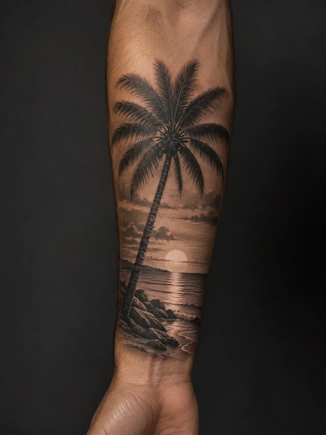 Palm tree and sunset beach tattoo on the forearm