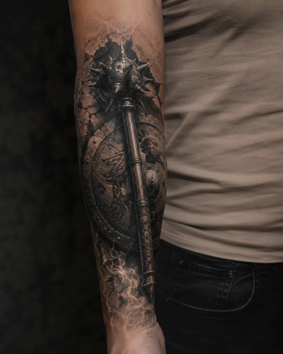 Spiked medieval mace and battered shield tattoo on forearm
