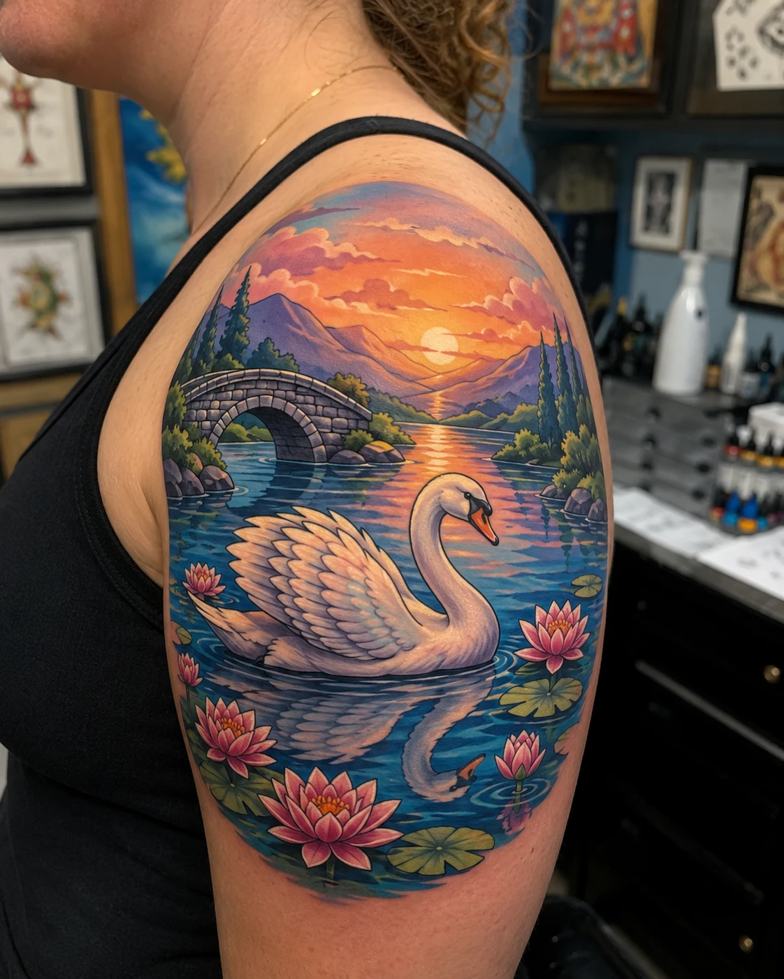 White swan glides across a glowing lake framed by reeds, flowers and amber evening sky.